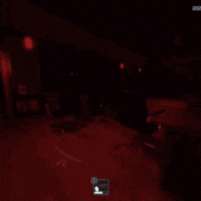 a screenshot of a video game with a red light shining on the floor