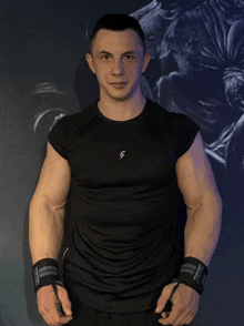 a man is wearing a black shirt with the letter f on the front