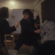 a man in a suit is fighting another man in a white shirt in a dark room