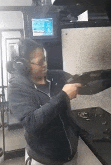a man wearing headphones is holding a gun