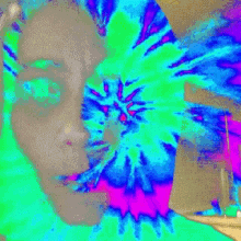 a colorful painting of a woman 's face with a swirl in the middle