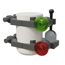 a lego model of a cylinder with green and red buttons