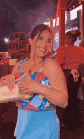 a woman wearing a blue top that says colcci