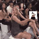 a group of people sitting in a room with a picture of a grammy award in the background
