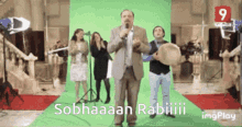 a group of people standing in front of a green screen that says sobhaaan rabiii