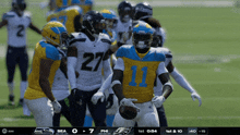 a football player in a yellow and blue uniform with the number 11 on it