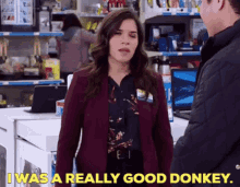 a woman in a purple jacket says i was a really good donkey while talking to a man