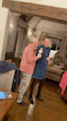 a blurry picture of two people standing in a living room