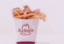 a blurry picture of a person 's face with a hamburger on it .