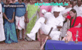 a man in a cricket uniform is jumping in the air in front of a crowd and the website starttamilchat.in is visible