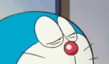 a close up of doraemon 's face with a red nose