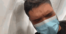 a man wearing a face mask is crying on a plane