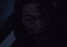 a person with blood on their face looks at the camera