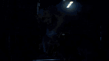 a person holding a stuffed animal in their arms in a dark room