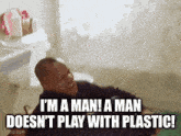 a man is laying on the floor in a bathroom and laughing while saying i 'm a man