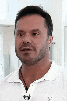a man with a beard is wearing a white shirt that says nike on the front