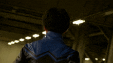 a blurry picture of a person in a blue jacket