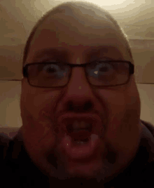 a man wearing glasses making a funny face