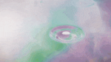 a close up of a drop of water on a surface
