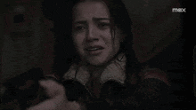 a woman is crying while holding a gun in front of her face ..