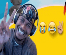 a man wearing headphones and a bandana is giving a peace sign .