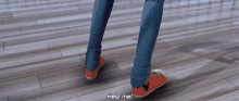 a person standing on a wooden floor with help me written on the floor