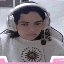 a girl wearing headphones and a shirt that says ' vibe '
