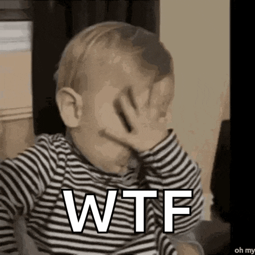 a baby is covering his face with his hand and the word wtf is written on it .