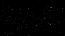 a black background with a lot of white bubbles floating in the air .