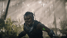a poster for predator badlands with a monster in the woods