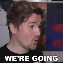 a man with a beard is making a funny face and saying we 're going