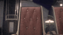 a girl with purple hair is sitting in a chair with her hands outstretched