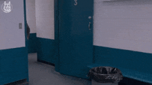 a man in a suit and tie is jumping in the air while standing in a hallway .