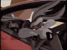 a cartoon character is sitting in a red car