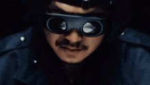 a close up of a man 's face wearing a pair of glasses