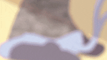 a blurred image of a person 's feet with a purple and white blanket on a yellow background .