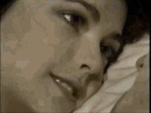a close up of a man 's face with a woman behind him .