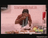 a man is sitting on the floor eating food with the words starttamilchat.in written above him