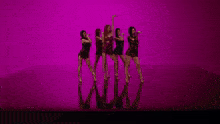 a group of women are dancing in front of a purple backdrop