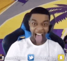 a man is sitting in a chair with his tongue sticking out .