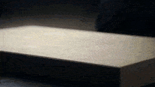 a close up of a box on a table with a light shining on it .