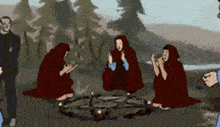 a group of people are sitting around a fire in a forest