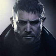 a close up of a man 's face with a beard wearing a black coat