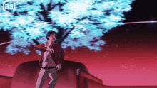 a man in a red jacket is standing in front of a tree with the letters as on the bottom right