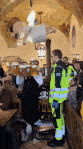 a man carrying a tray of beer stands in front of a crowd