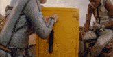 a man in a wet suit is opening a safe