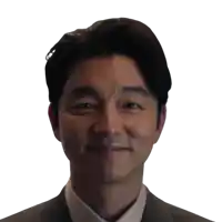a man in a suit and white shirt is smiling