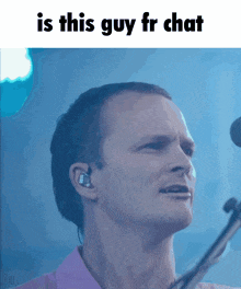 a man singing into a microphone with the caption " is this guy fr chat " above him