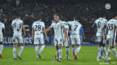 a group of soccer players are standing on a field and one has the number 28 on his back
