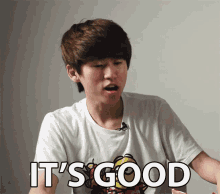 a young man wearing a white t-shirt with the words it 's good on it